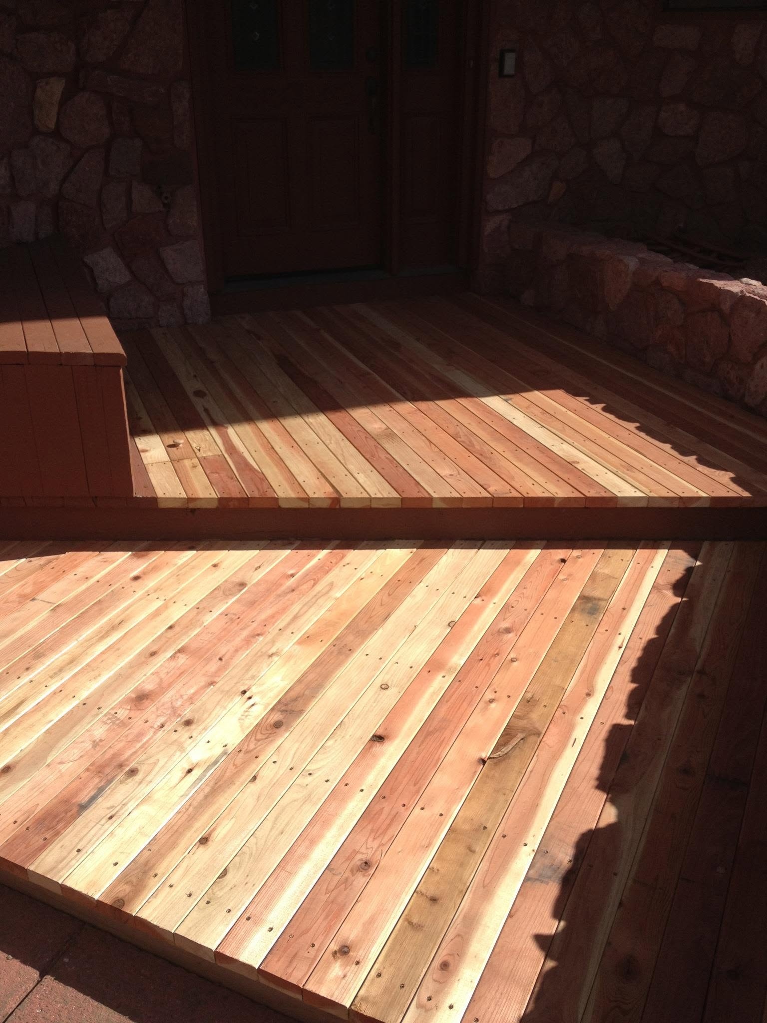 Close-up of composite deck boards with black metal railings in Colorado Springs, CO