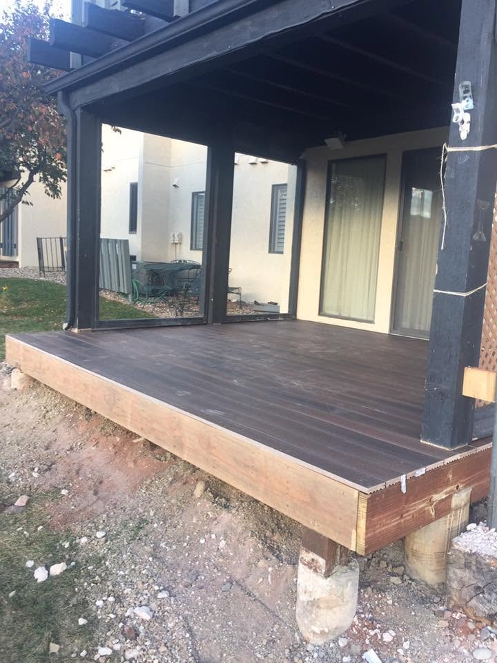 New deck build with dark stained wood decking and covered pergola — Colorado Springs, CO