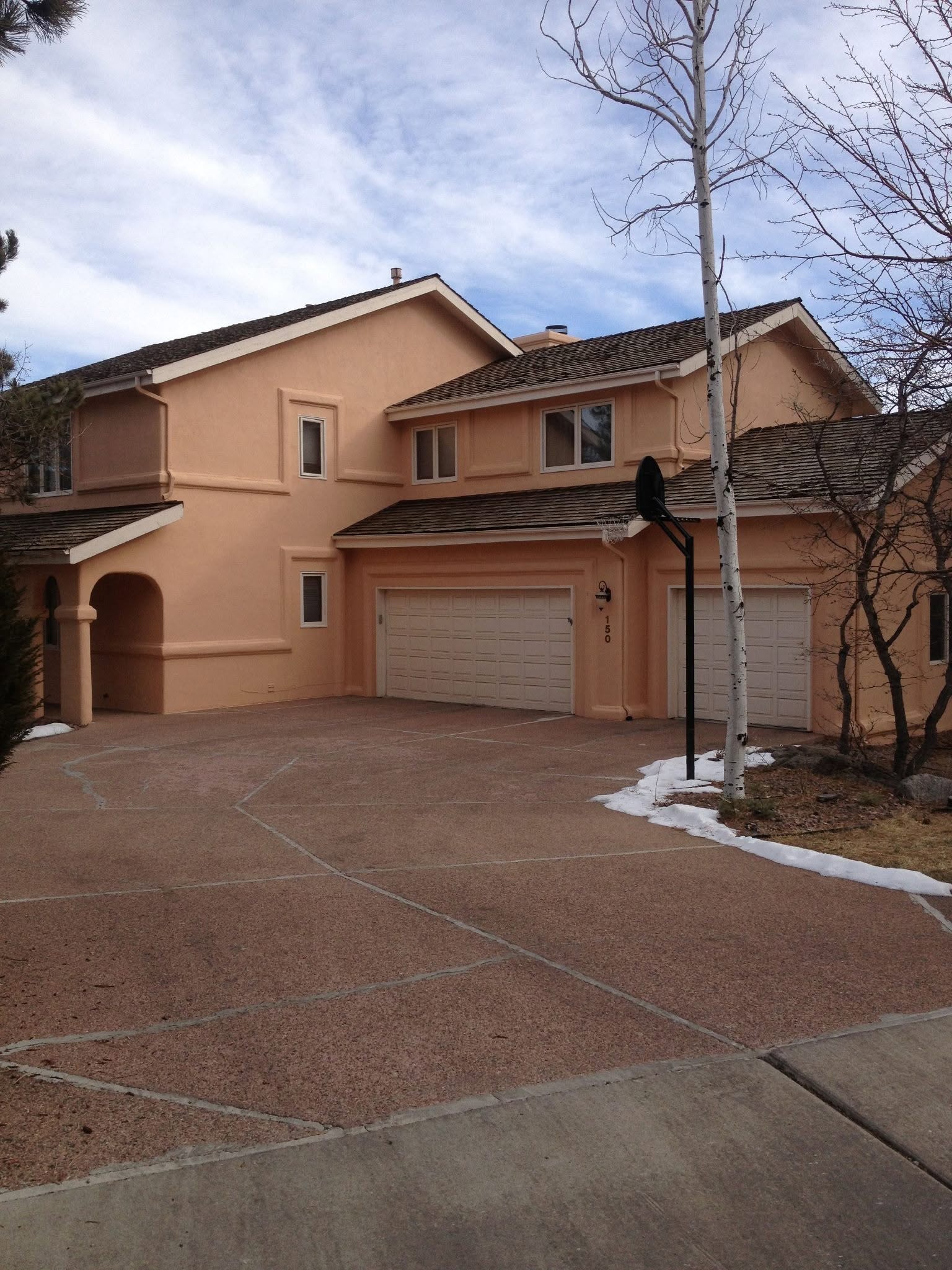 Freshly coated peach stucco home exterior in Pueblo, CO — Confident Coatings