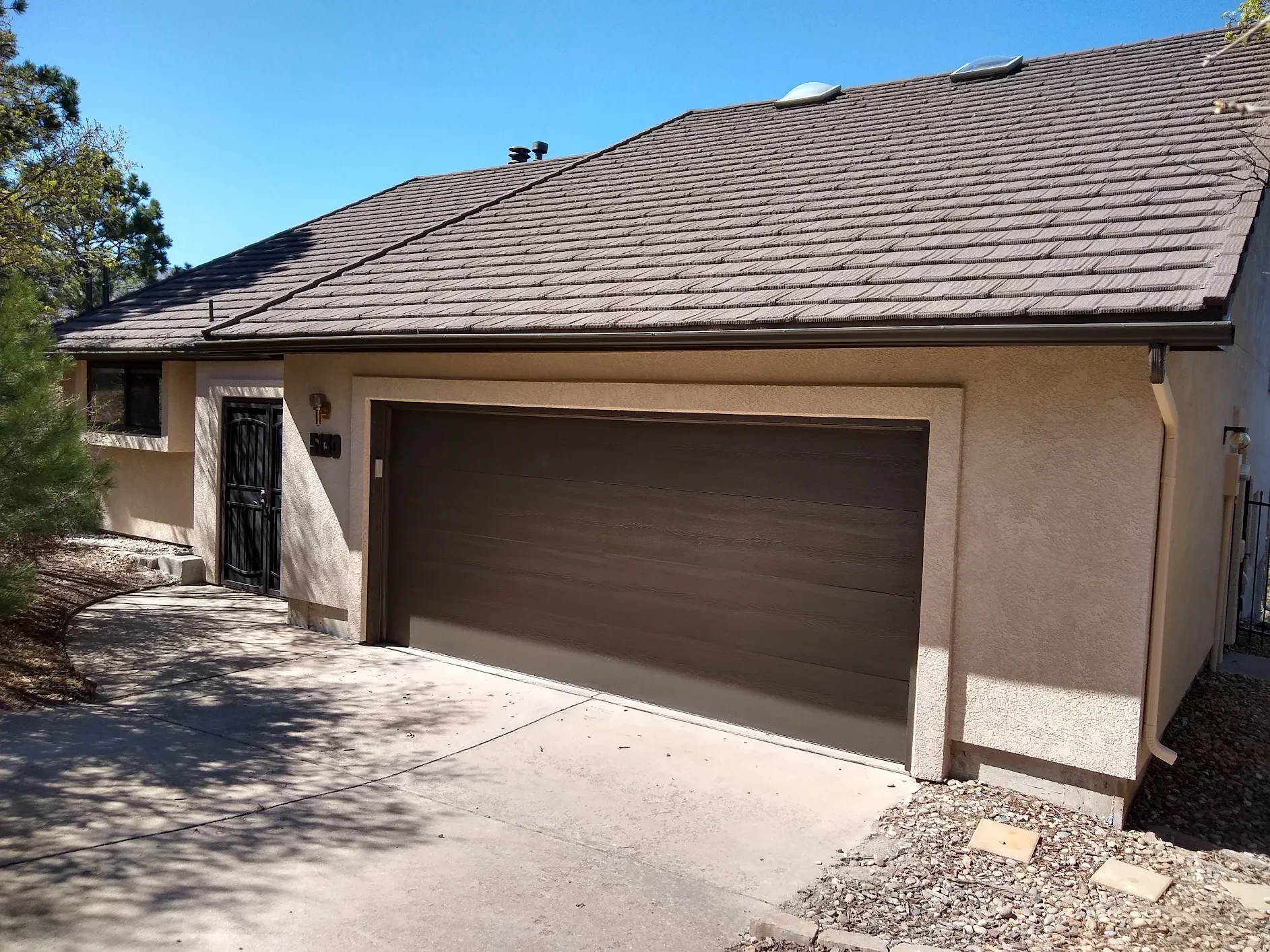 After — completed exterior painting and stucco repair by Confident Coatings