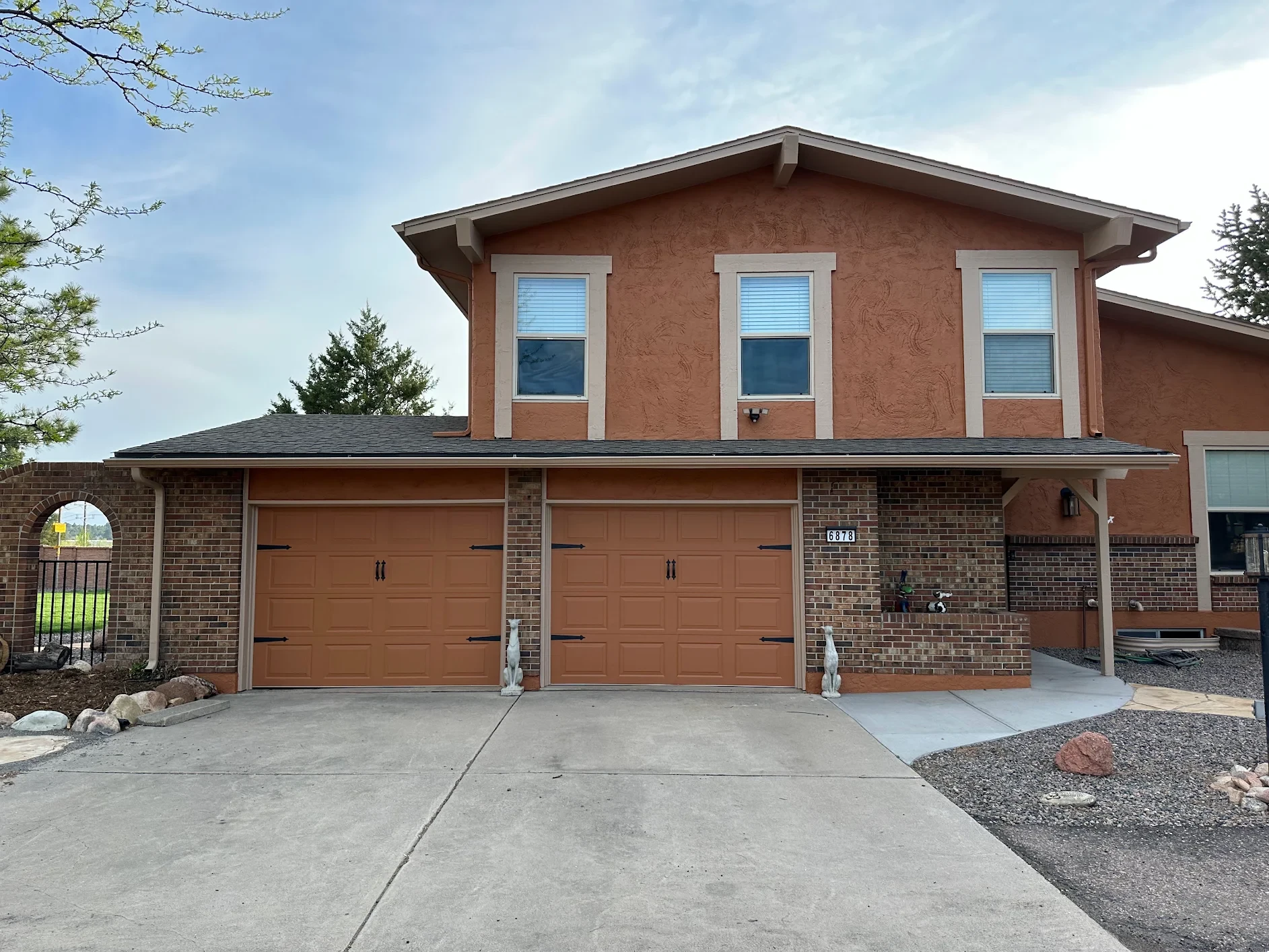 After — completed exterior painting and stucco repair by Confident Coatings