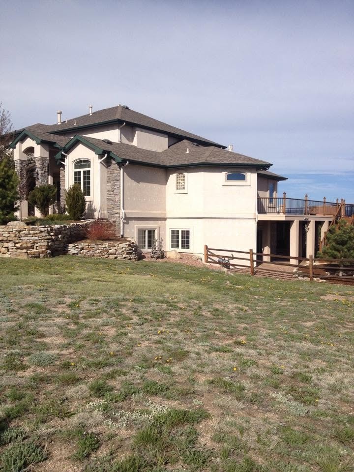 Adobe pueblo-style stucco home with visible weathering — before stucco repair in Colorado Springs, CO